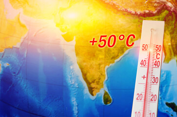 A thermometer with a record high temperature of fifty degrees Celsius, against the backdrop of the...