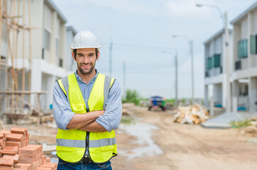 Portrait of male civil engineer wears safety vest with white helmet standing arms crossed at...
