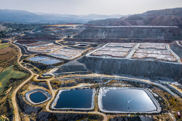 Leaching heaps and storage reservoirs at ore processing plant. Skouriotissa copper mine in Cyprus - obrazy, fototapety, plakaty