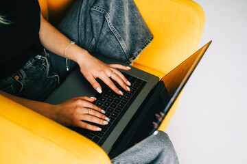 Young woman mobile developer writes program code on a computer, programmer work.
