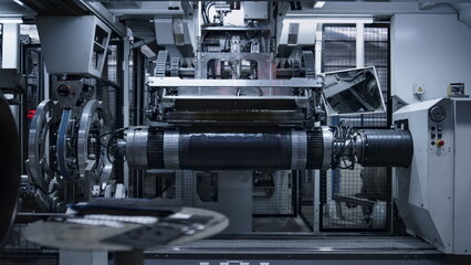 Robotic tyre plant worker operating production process in factory close up