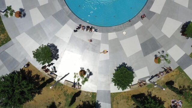 Aerial top down view of Dizengoff Square in Tel Aviv, Israel. People enjoying the sunshine with a blue fountain at its center on a sunny day. One of the City's iconic public spaces.
