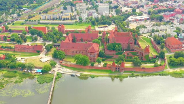 Malbork,Poland.Aerial 4K video from drone to Medieval Malbork ( Zamek w Maborku, Ordensburg Marienburg ),castle in Poland fortress of the Teutonic Knights at the Nogat river in sunrise light.(Series)