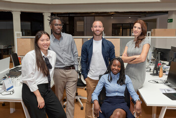 Portrait of a successful creative multi-ethnic business team looking at the camera and smiling, in a coworking space