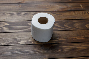 toilet paper roll on wooden background.