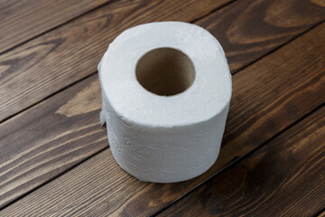 toilet paper roll on wooden background.