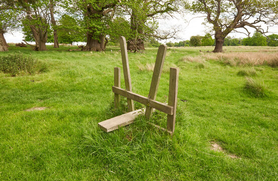 Isolated wooden fence stile in a field