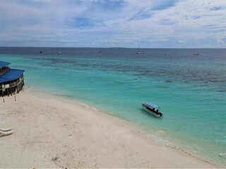 Fototapeta na wymiar Views of a white sand beach in Zanzibar