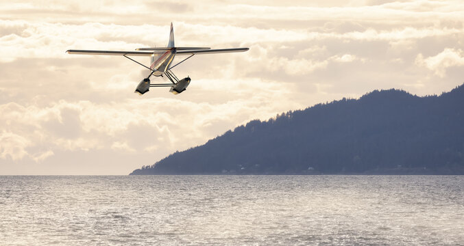 Seaplane flying over Canadian Mountain Nature Landscape on the Pacific West Coast. Cloudy and fog Spring Day. 3d Rendering Airplane Adventure Concept. Vancouver, British Columbia, Canada.