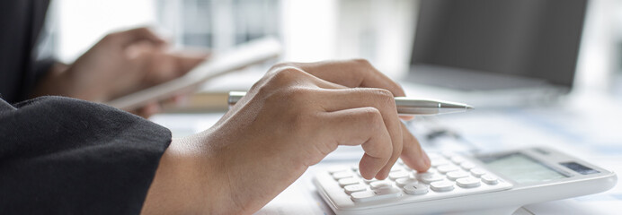 Accounting businessmen are calculating income-expenditure and analyzing real estate investment data, Dedicated to the progress and growth of the company, Financial and tax systems concept.