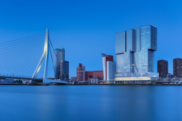Rotterdam, Holland. View of the Erasmus Bridge and the city center. Long exposure photography. Cityscape in the evening. Skyscrapers and buildings.