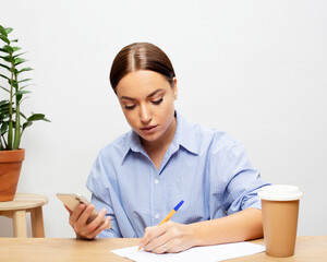 Freelance, business and people concept: Stylish young woman working with mobile in her home office