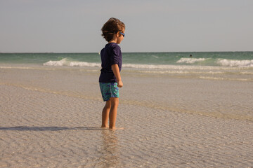 boy playing on Sunset Beach  located at the southern tip of Treasure Island, Florida in Pinellas County.