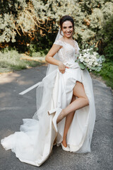 A cheerful bride poses for the camera. Shows her leg 