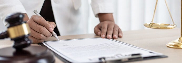 Judge or a lawyer works documents in the courtroom and analyze the various laws for justice and accuracy, Litigation and justice concept.