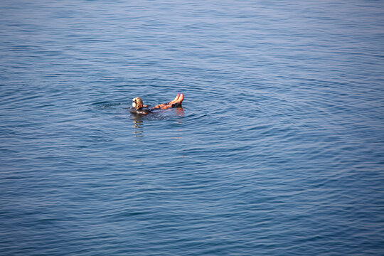 Woman floating in the dead sea, Jordan
