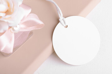 Round gift tag mockup with beige wedding favor on a white background, Wedding favor tag for...