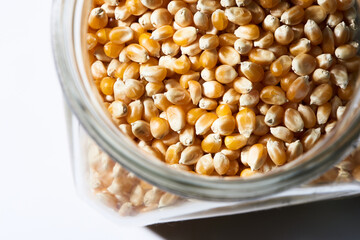 popcorn kernels in jar on white