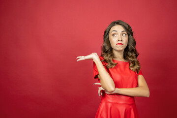 Woman is disappointed on a red background