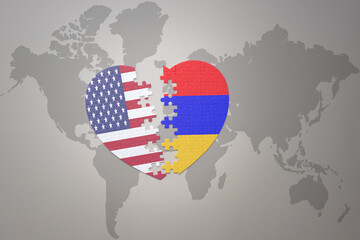 puzzle heart with the national flag of united states of america and armenia on a world map background. Concept.
