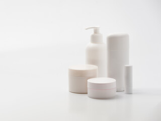 Fototapeta na wymiar Template or mock up of white and blank containers of cosmetics for trademark design