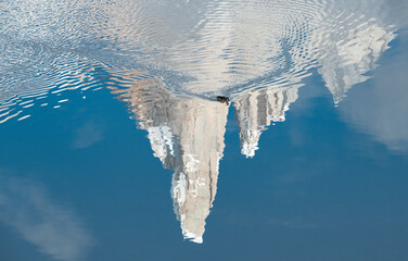 A duck winds a path, stirring up a reflection of Cerro Torre in