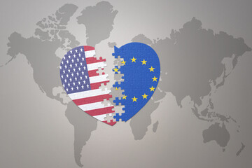 puzzle heart with the national flag of united states of america and european union on a world map background. Concept.