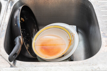 Dirty dishes in the sink after lunch.