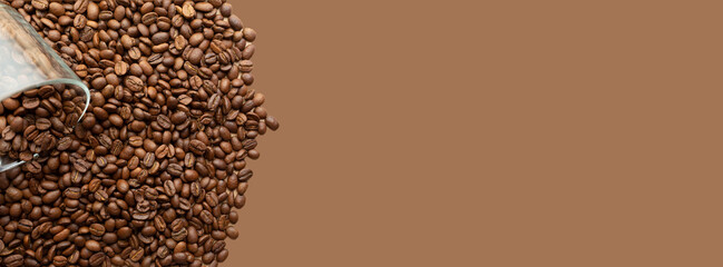 Banner with roasted coffee beans. Place for your text and label. Coffee beans are poured from a glass cup. Light brown background. Advertising layout for a coffee shop. Top view, flat lay. Copy space.