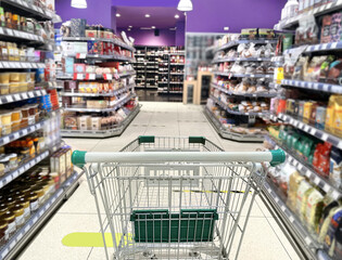 choosing a dairy products at supermarket.empty grocery cart in an empty supermarket