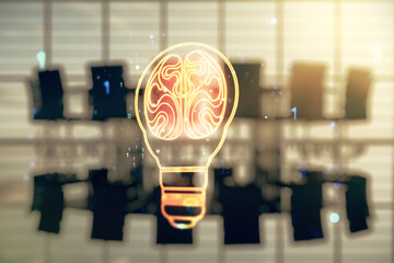 Double exposure of abstract virtual creative light bulb hologram with human brain on a modern...