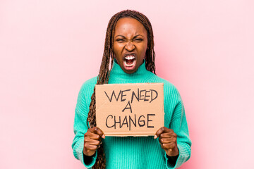 Young African American woman holding we need a change placard isolated on pink background