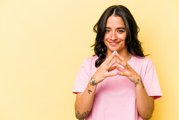 Young hispanic woman isolated on yellow background making up plan in mind, setting up an idea.
