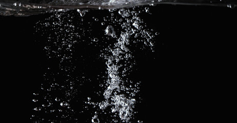 Blurry images of clear transperant soda liquid bubbles splashing or sparkling and moving up in...