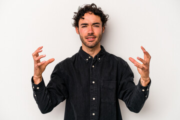 Young caucasian man isolated on white background screaming with rage.