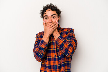 Young caucasian man isolated on white background shocked covering mouth with hands.