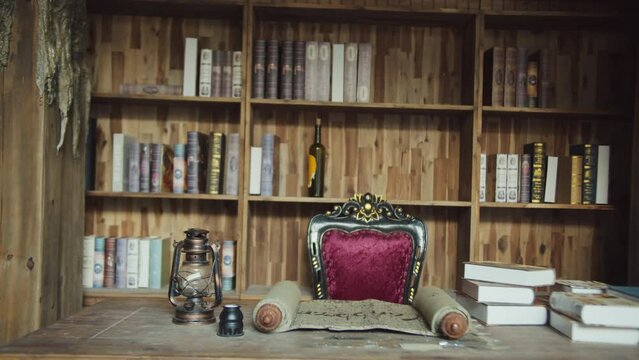 Fireplace in a cozy cabin. The cat is sitting in an armchair by the burning fireplace. Cozy forest house with a burning fireplace. Relaxation environment. Interior of a wooden cottage with window. 4K