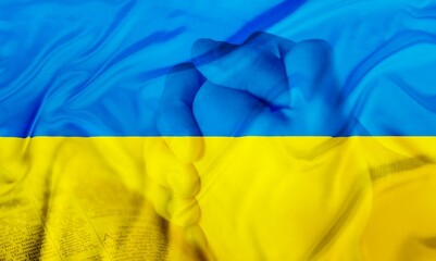 Sad man with Ukraine flag  double exposition at background praying. Concept of standing with Ukrainian