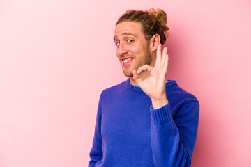 Young caucasian man isolated on pink background cheerful and confident showing ok gesture.