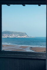 Scarborough South Bay Beach throw windows, Castle in the distance, low tide and bright blue sky