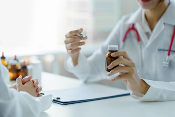 Female doctor asks about the patient's condition and makes recommendations about medications and...
