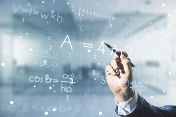 Double exposure of male hand with pen working with scientific formula hologram on blurred office...