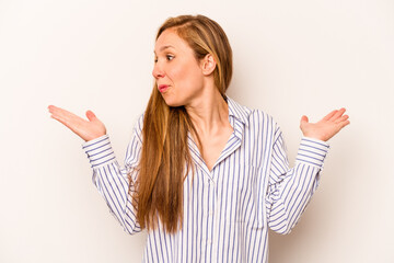Young caucasian woman isolated on white background confused and doubtful shrugging shoulders to...