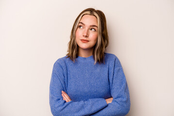 Young caucasian woman isolated on white background dreaming of achieving goals and purposes