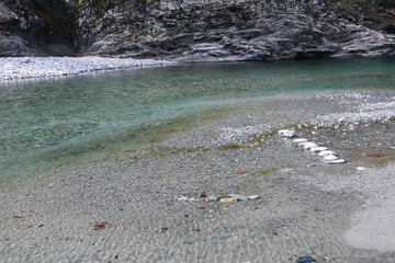 Stone Steps leading through the clear Maggia River flowing in the Maggia Valley in the Ticino in Switzerland