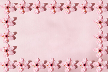 Fototapeta na wymiar Flower pattern forming a frame to enter text. Flowers on pink background
