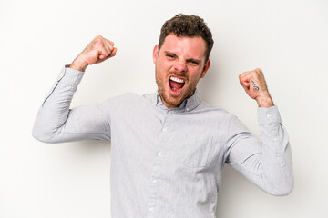 Young caucasian man isolated on white background cheering carefree and excited. Victory concept.