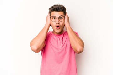 Young caucasian man isolated on white background being shocked, she has remembered important...