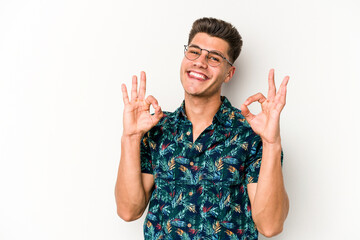Young caucasian man isolated on white background cheerful and confident showing ok gesture.