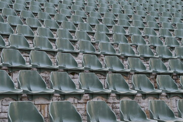 Rows of empty plastic chairs for open-air theater audiences